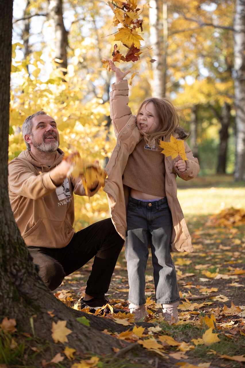 Man and young girl playing happily outdoors together